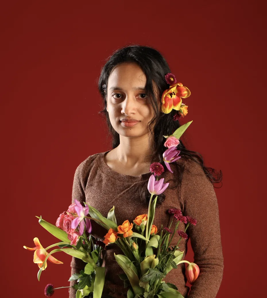Portrait with bouquet, crimson backdrop